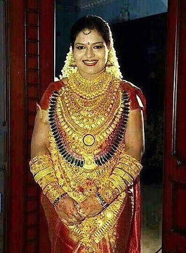 Photo Credit  http://www.dailymail.co.uk/news/article-2842661/Something-gold-new-Indian-bride-wears-400-000-jewellery-wedding-day-father-manages-upstage-collection-chains.html An Indian sweet maker made sure his daughter was the golden girl at her upcoming wedding by covering her in gold jewellery worth more than 400,000 GBP. The man who was not named nevertheless came under fire after it was revealed he needed a police guard to protect him and his daughter as they turned up covered in gold for the wedding in India's southern Andhra Pradesh state. Police spokesman Sandeep Kumar in Tirupati, a holy city known for its famous temple of Lord Vishnu, confirmed that the man and his daughter, who he declined to name, had worn gold jewellery throughout the ceremony. He said: "It is not a crime to wear such a large amount of gold, but there could have been a crime once people heard about it. We just wanted to make sure there were no problems in advance." The move was widely condemned on social media sites once the images from a mobile phone was shared, with people branding it both humiliating and shocking. Indians, one of the world's largest consumers of gold, spend huge amounts in buying gold jewellery for family weddings, and recently several wealthy Indians have been seen sporting shirts made out of solid gold thread. This father of the bride reportedly made his millions from selling confectionery in India. (ends)