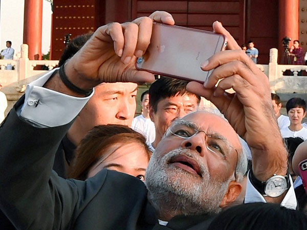 Photo Credit http://www.oneindia.com/feature/narendra-modi-from-taking-selfies-to-playing-musical-instruments-he-has-done-it-all-1750291.html